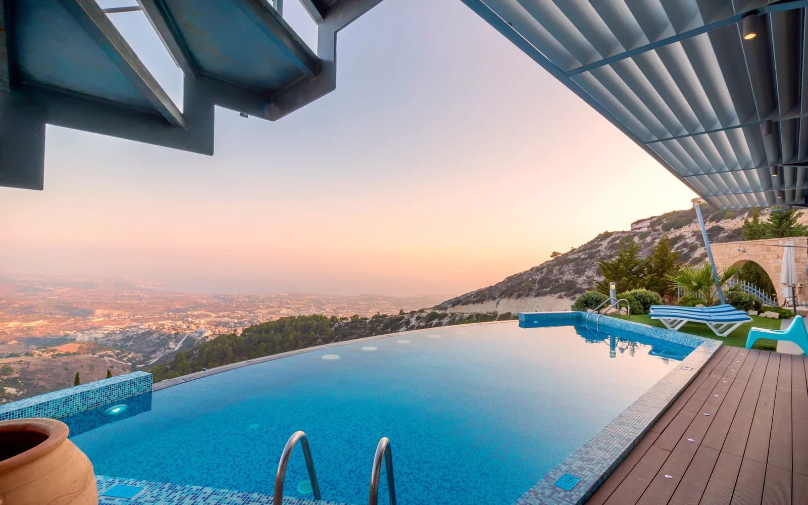 Geometric infinity pool overlooking a sunlit valley and distant mountains, Phoenix metro style